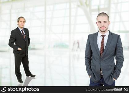 two business men standing at the office