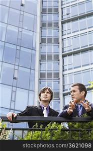 Two business men talking outside office