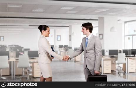 Two business partners shaking hands. Professional business people shaking hands as symbol of deal in office