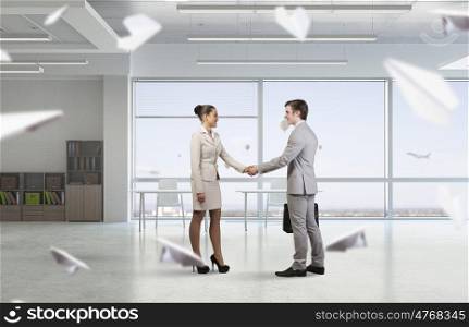 Two business partners shaking hands. Professional business people shaking hands as symbol of deal in office