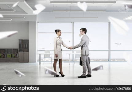 Two business partners shaking hands. Professional business people shaking hands as symbol of deal in office