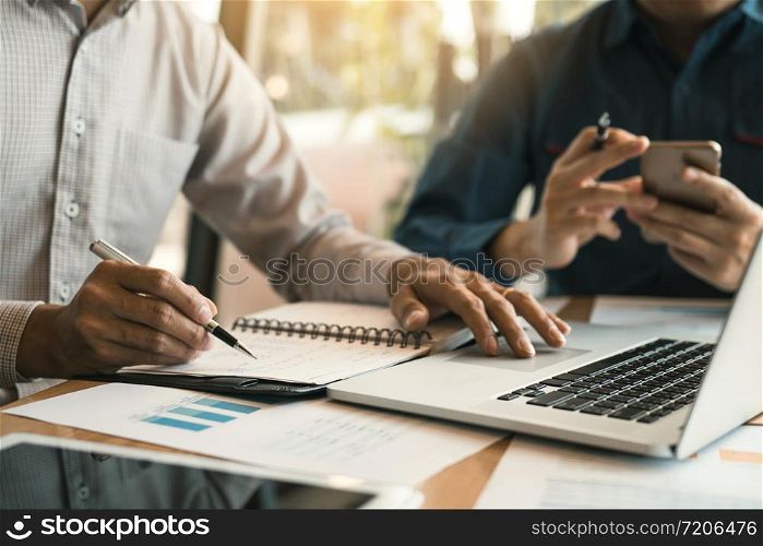 Two business partnership coworkers analysis strategy and gesturing with discussing a financial planning graph company during a budget meeting in office room.