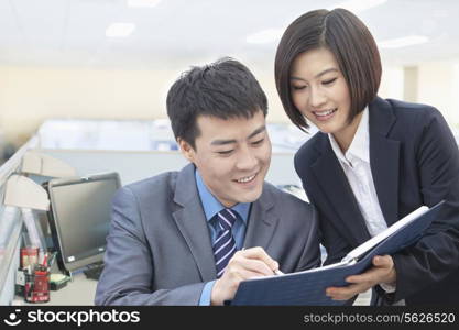 Two Business People Looking at Note Pad