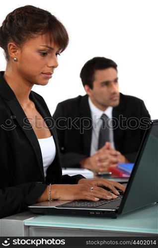Two business people sat next to each other