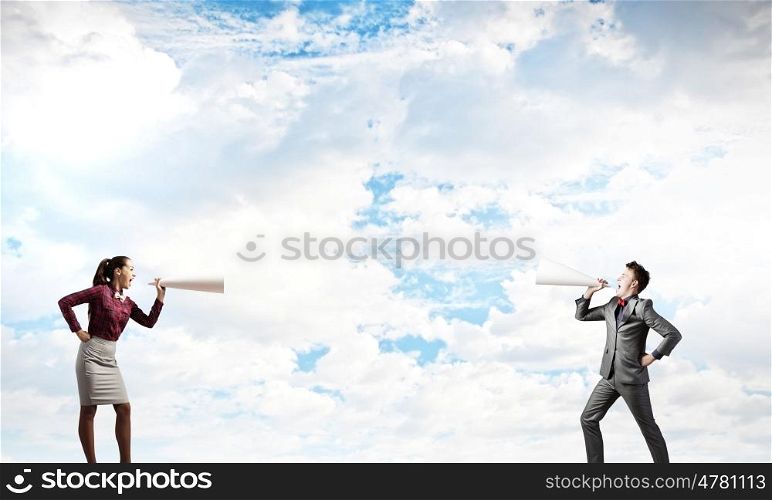 Two business people shouting in megaphones at each other. Business conflict