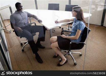 Two business people sitting at a conference table and discussing during a business meeting