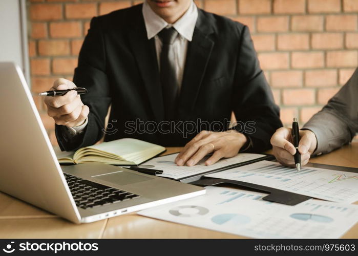 Two business people talking and analysis about finance budget company in office room.