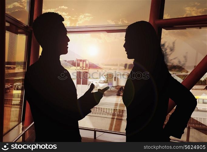 Two business people talking in the airport, Silhouette