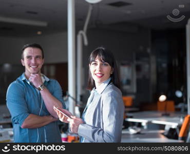 two business people using tablet preparing for next meeting and discussing ideas