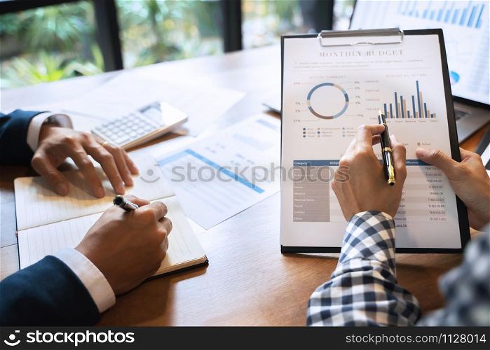 Two business teamwork calculating a valuation in workplace.