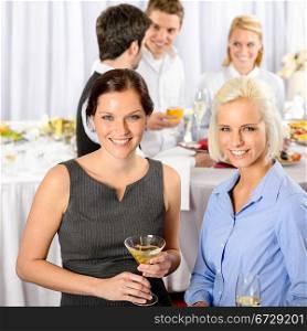 Two business woman smiling at catering buffet company meeting