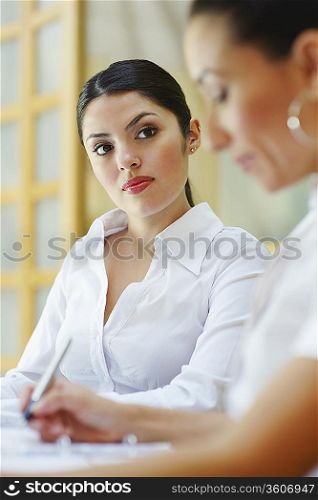 Two business women sitting in meeting