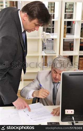 Two businessman discussing over a project at their workplace