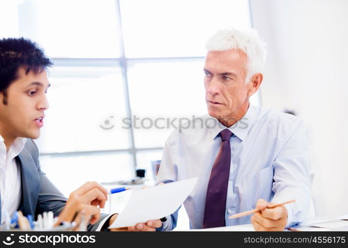 Two businessman in office having discussion. Discussion is the way to solution