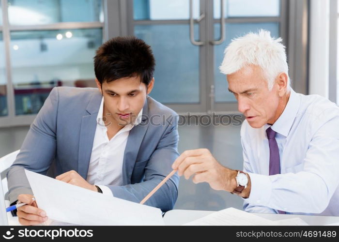 Two businessman in office having discussion. Discussion is the way to solution