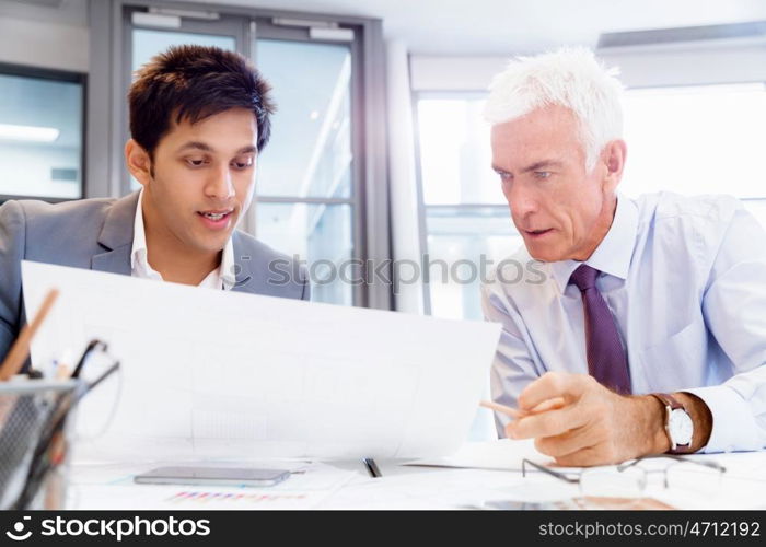 Two businessman in office having discussion. Discussion is the way to solution