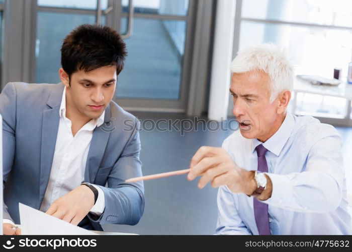 Two businessman in office having discussion. Discussion is the way to solution