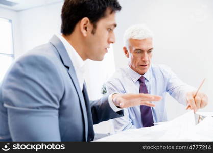 Two businessman in office having discussion. Discussion is the way to solution