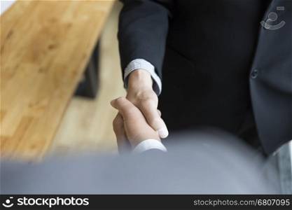 two businessman in suit shaking hands - business teamwork, cooperation concept