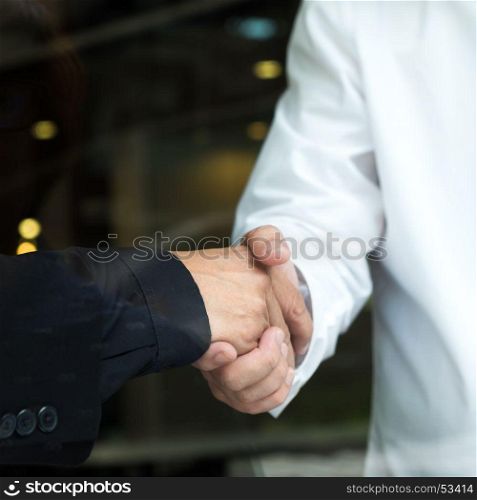 Two businessman shaking hands.