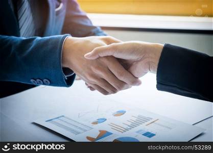 Two businessman shaking hands during a meeting in the office, success, dealing, greeting and partner concepts