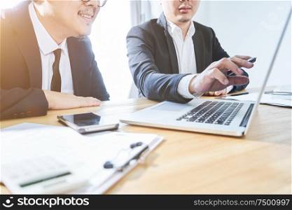 Two businessman using laptop to discuss finance and marketing solution .