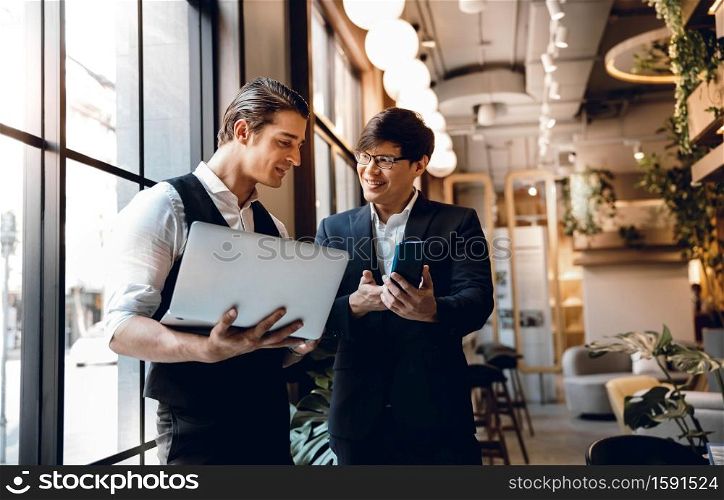 Two Businessman Working Together on Computer Laptop in Creative Workplace. Happy Business Partnership People