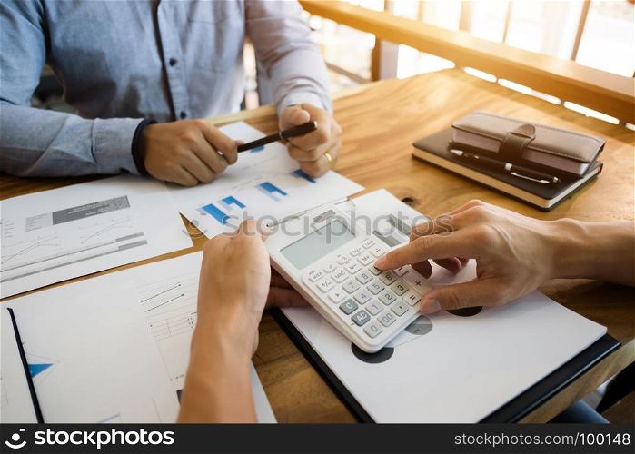 two businessman working together with financial report