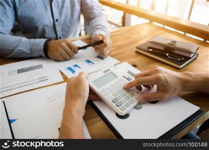 two businessman working together with financial report