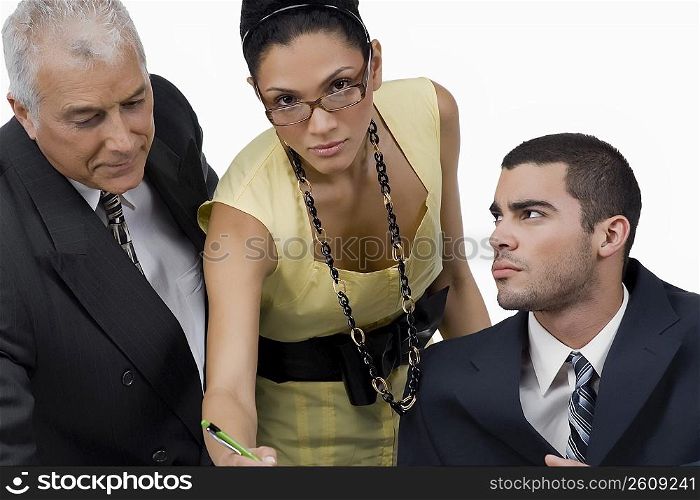 Two businessmen and a businesswoman discussing