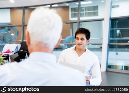 Two businessmen during interview in office. Doing business is about people