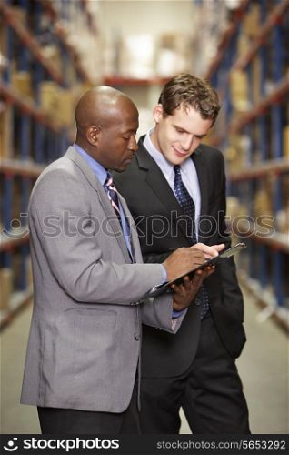 Two Businessmen Having Discussion In Warehouse