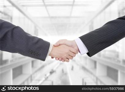 two businessmen in a handshake at the office
