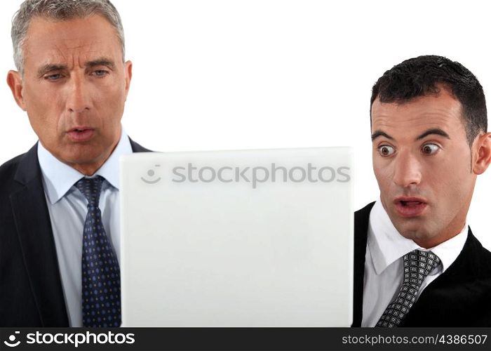Two businessmen look shocked