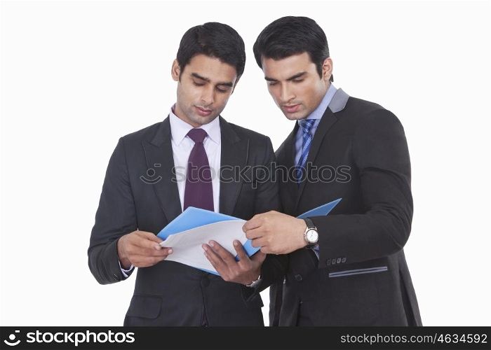 Two businessmen looking at a file