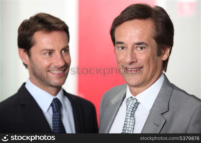Two businessmen smiling