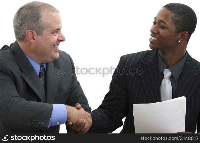 Two businessmen smiling and shaking hands.