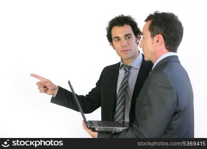 Two businessmen stood with laptop
