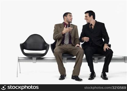 Two businessmen talking to each other