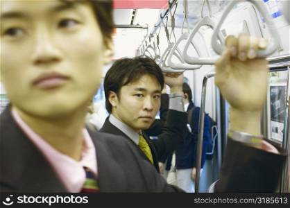 Two businessmen traveling in a train