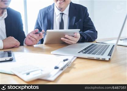Two businessmen use electronic products in discussing business plan
