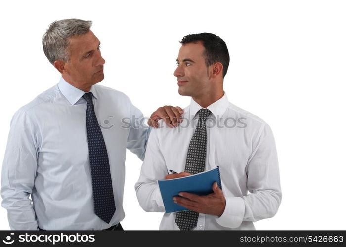 Two businessmen with a report