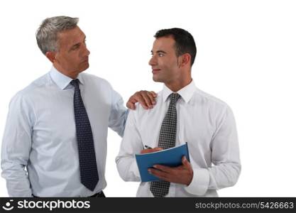 Two businessmen with a report