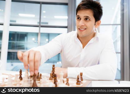 Two businessmen with chess in office. Strategic play