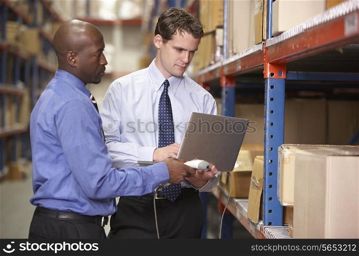 Two Businessmen With Laptop In Warehouse