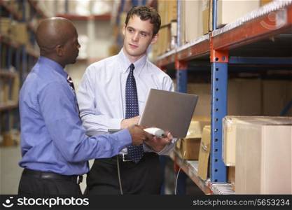 Two Businessmen With Laptop In Warehouse