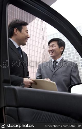Two businessmen working outside