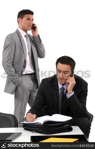 Two businessmen working towards deadline