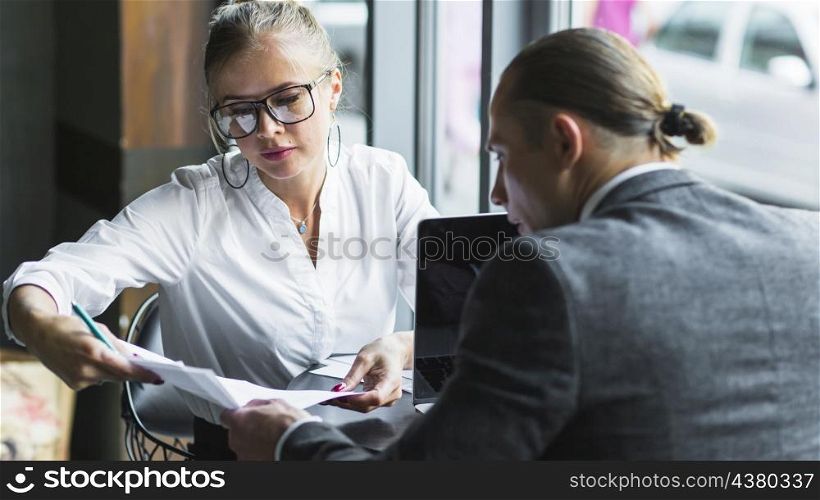 two businesspeople checking agreement restaurant