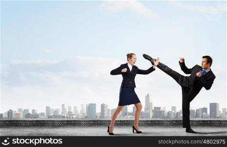 Two businesspeople in anger fighting with each other. Extreme office quarrel